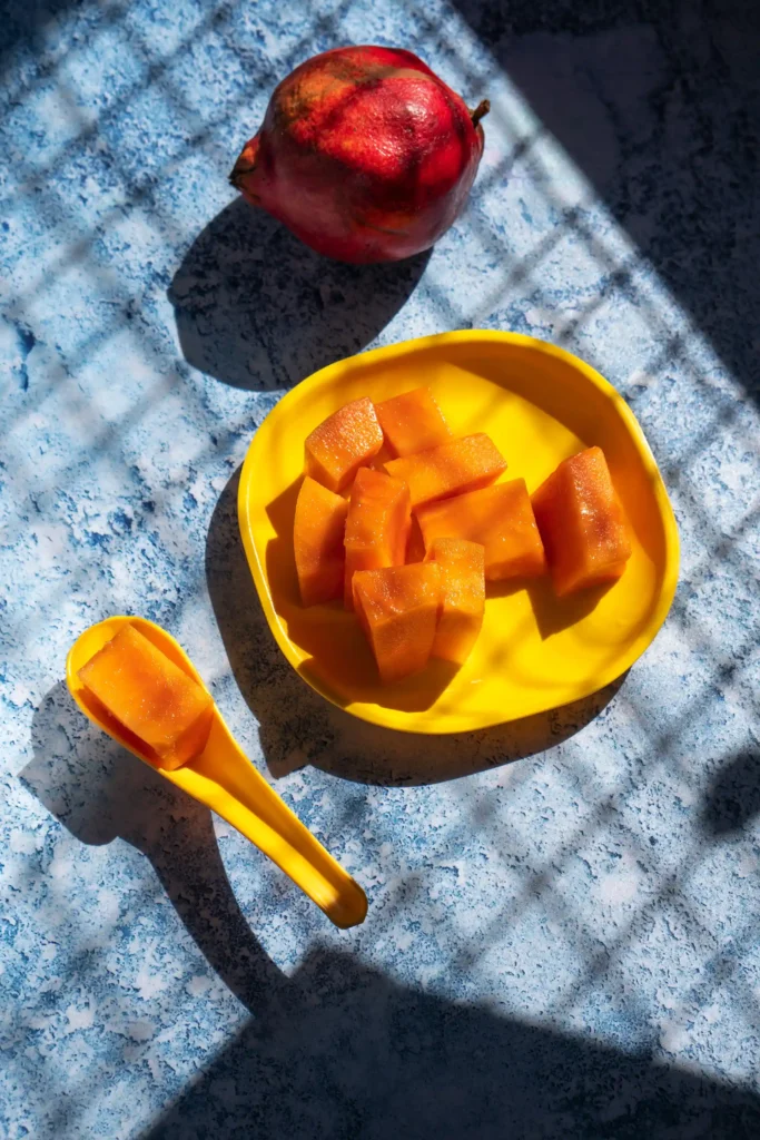 Fresh Papaya pieces with red pomegranate