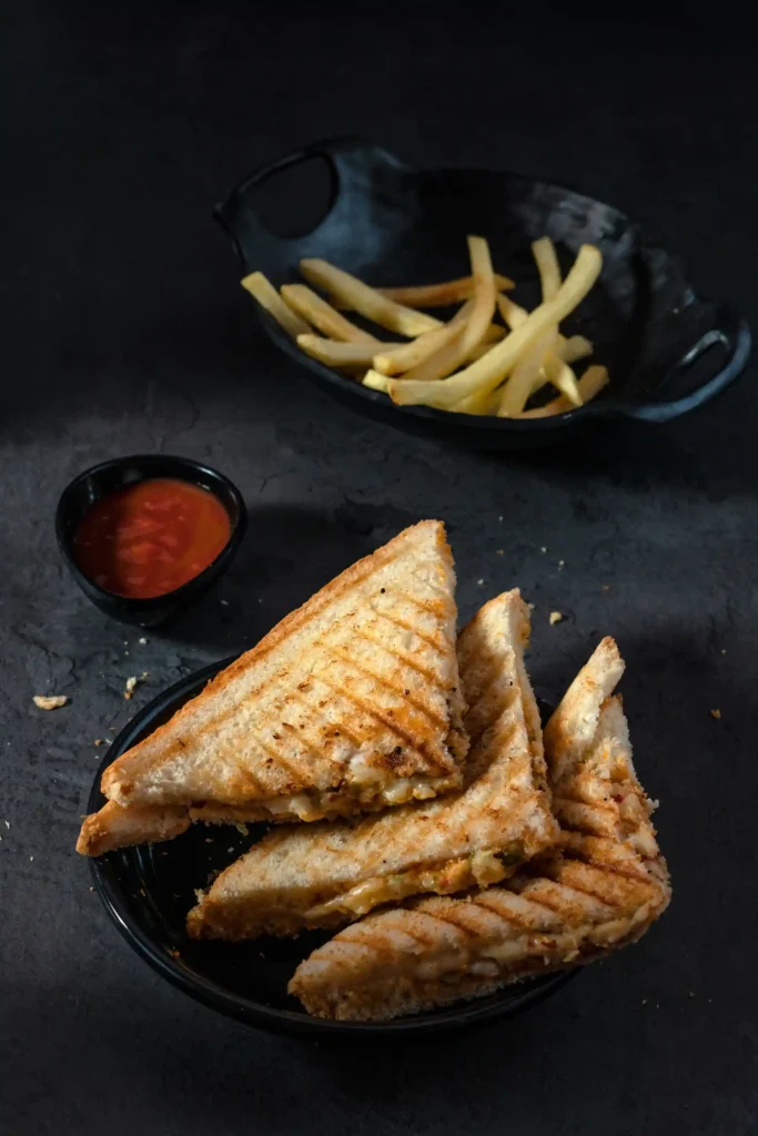 Veg sandwich with sauce and French fries