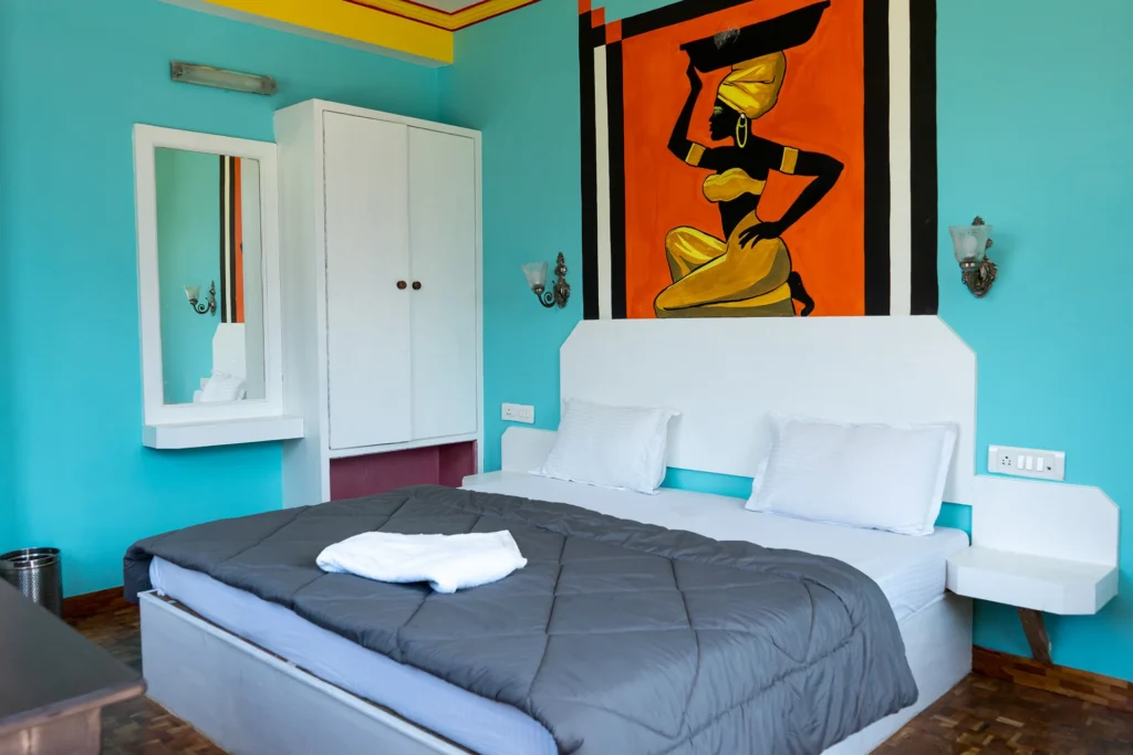 Colourful clean room with white bed