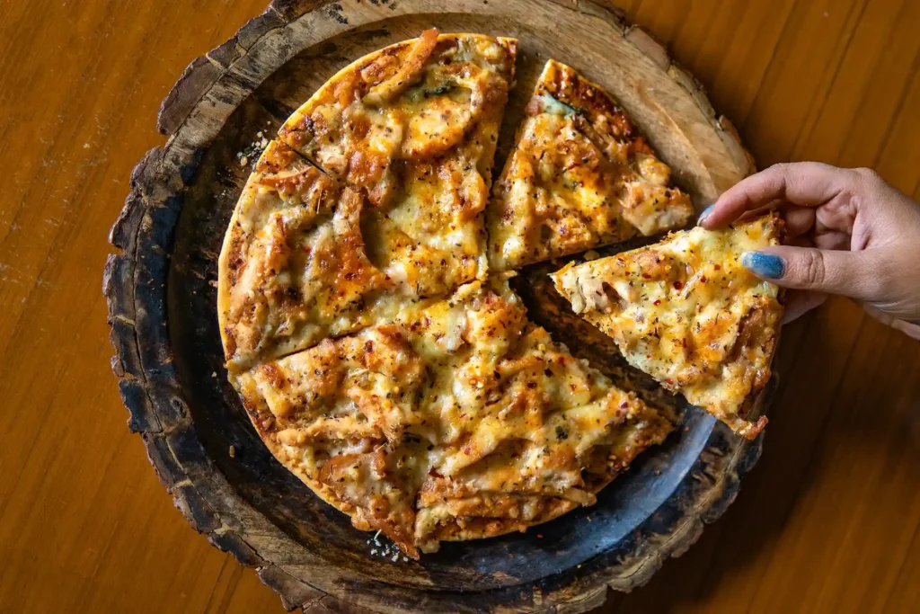 Cheesy Pizza on wooden plate